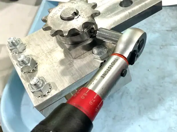 Torque wrench tightening a sprocket on an aluminum subassembly for exercise equipment