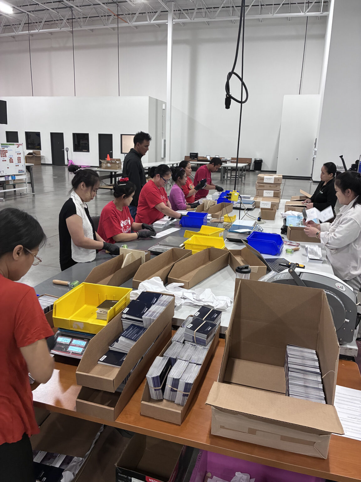 Team members working a packaging and assembly line on the RELY floor