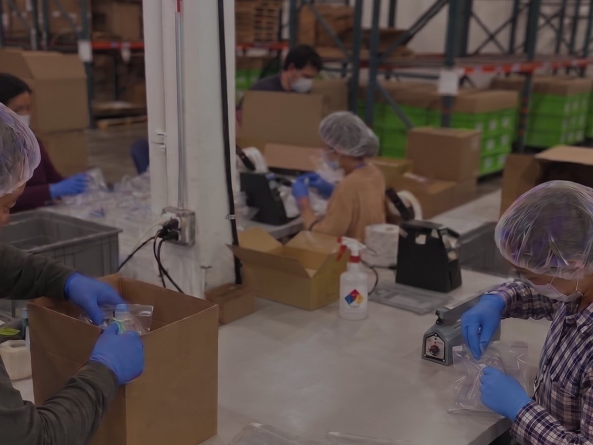 RELY associates bagging and packing medical masks during the 2021 mask program
